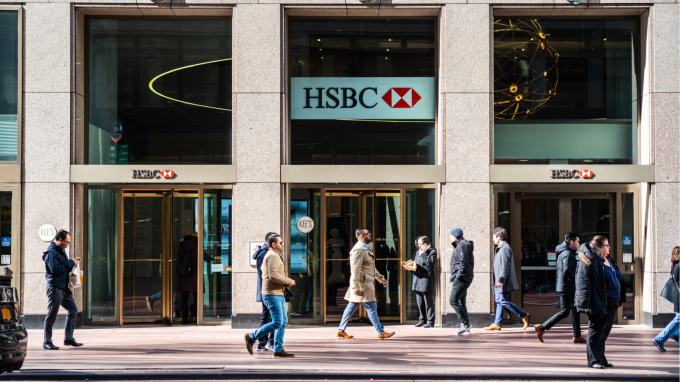 Pedestrians pass a branch of HSBC in New York