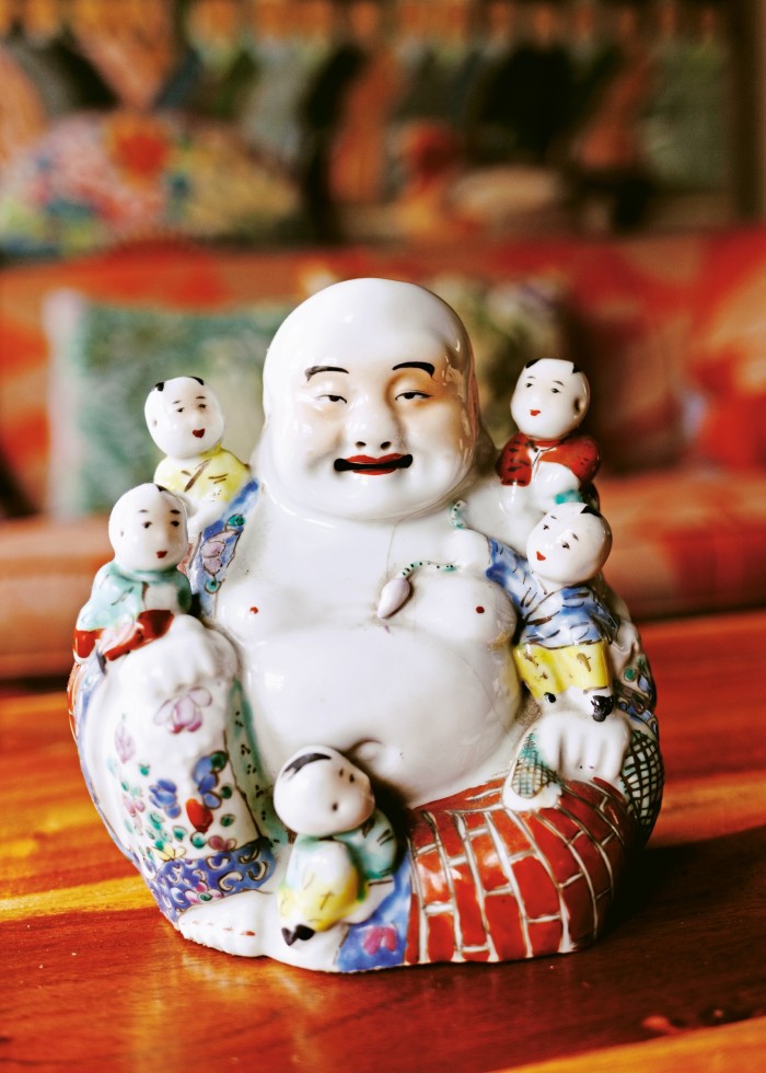 One of Fassett’s collection of antique laughing Buddhas