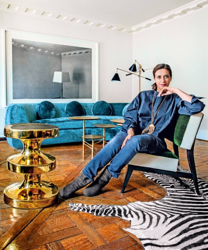 India Mahdavi with several of her designs: a Bishop stool, from €550, the velvet Jelly Pea sofa, from €18,500, and a Gelato armchair, €1,950