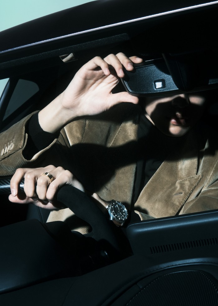 Bo wears Loro Piana cotton corduroy jacket, £2,345, and cashmere rollneck, £1,400. Dior gold and diamond Gem Dior ring, £7,600. Longines stainless-steel Spirit Zulu Time watch, £2,520. Throughout: Aston Martin Vantage coupé in Satin Xenon Grey, from £131,500