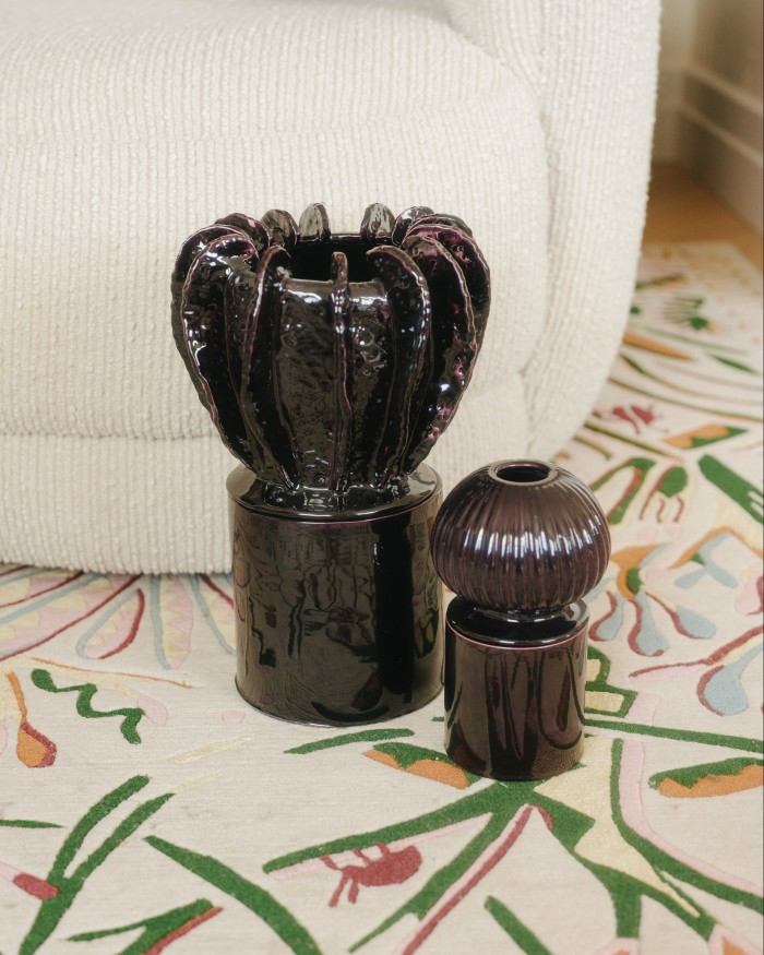 A pair of ceramic candle holders, produced by Atelier John Roger Paris 
