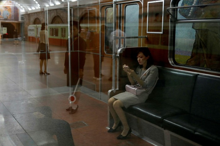 A woman sits in a train at a subway station in Pyongyang. The UN has accused ‘agents who police the marketplace, inspectors on trains, and soldiers’ of ‘committing acts of sexual assault on women in public spaces’