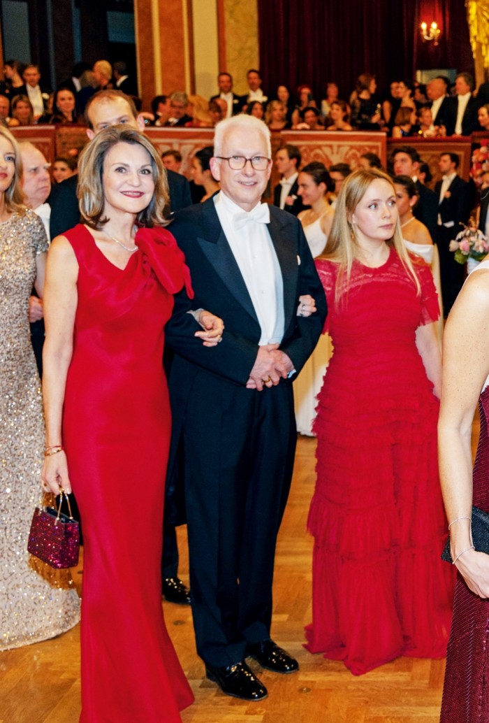 The author (right) enters the ball wearing a gown from the rental app Hurr, from about £60 for four days