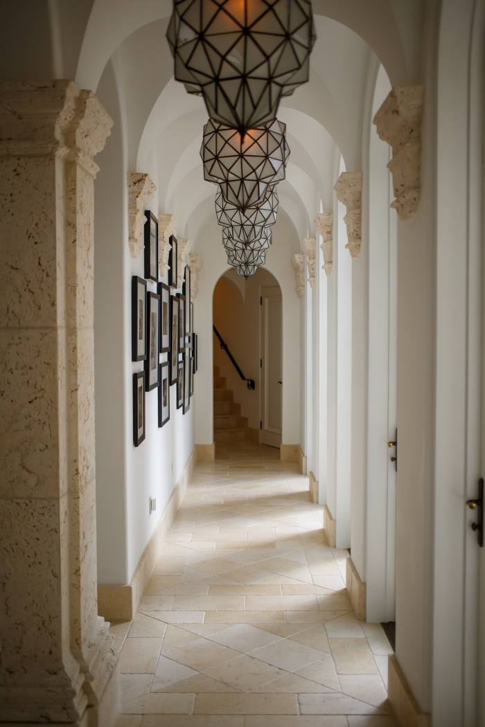 A white hallway with columns and lamps in Tommy Hilfiger’s house