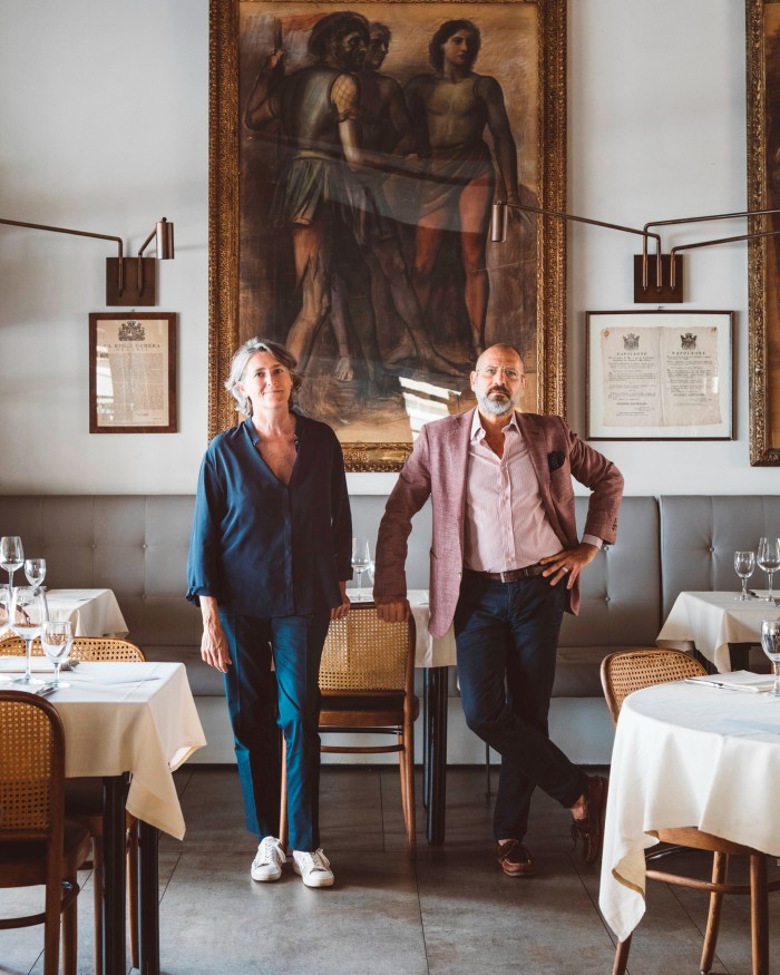 Siblings Simona and Claudio Romanini, the owners of Al Mercante, standing in its dining space