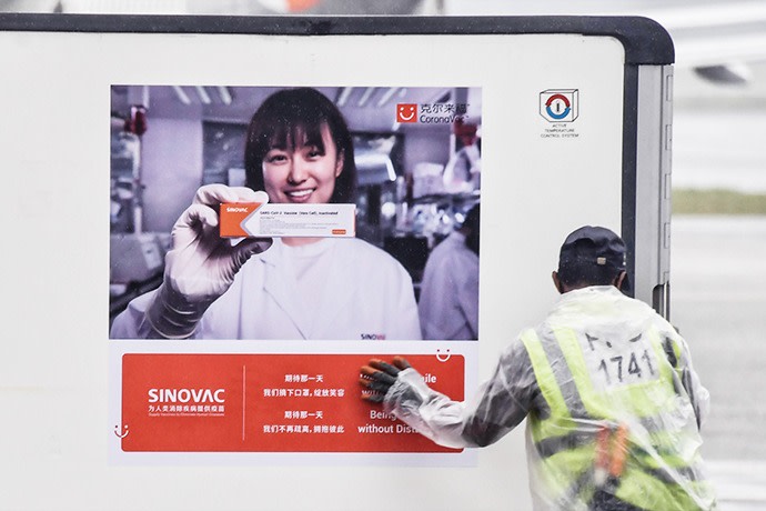 An advertisement for China’s SinoVac on the side of a truck