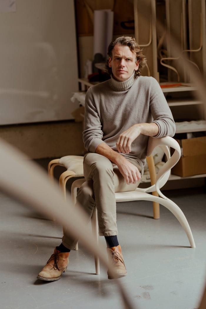 Joseph Walsh at his design studio in Fartha, County Cork. He sits on his own prototype for an Enignum Locus chair