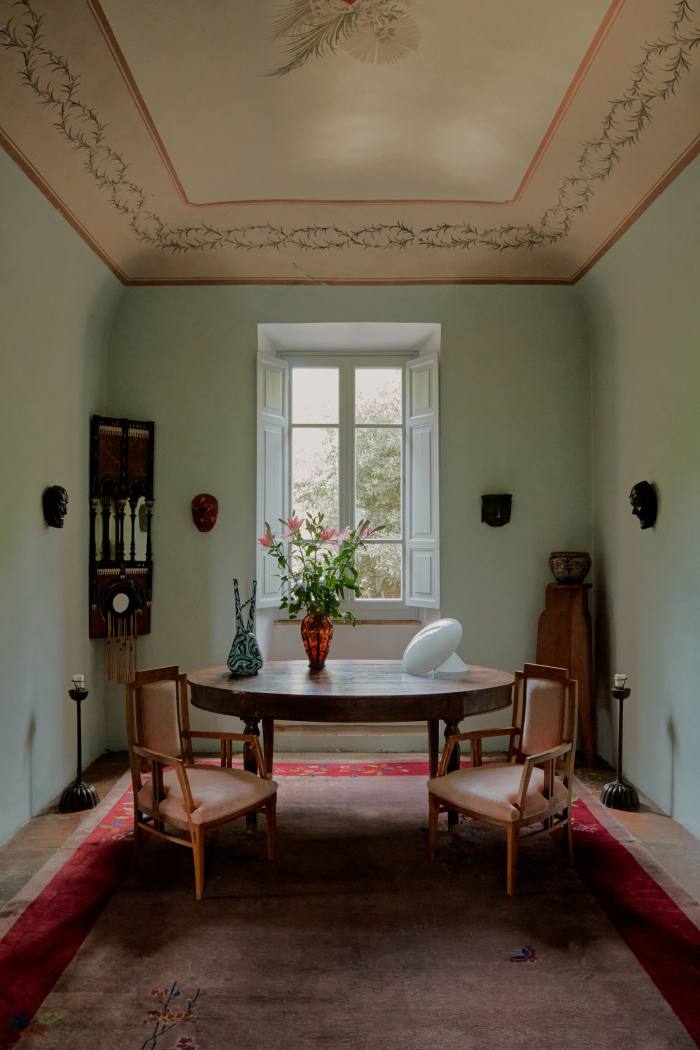 The upstairs sitting room contains (on table from left), a c1950 Solimene vase, a Louis Majorelle vase and a 1960s Vistosi Murano lamp. Japanese Bugaku masks line the wall. A Galileo Chini vase sits on a Duilio Cambellotti pedestal