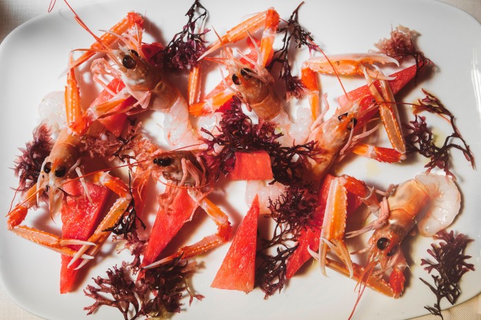 A plate of shelled raw langoustine, watermelon and seaweed at Al Mercante