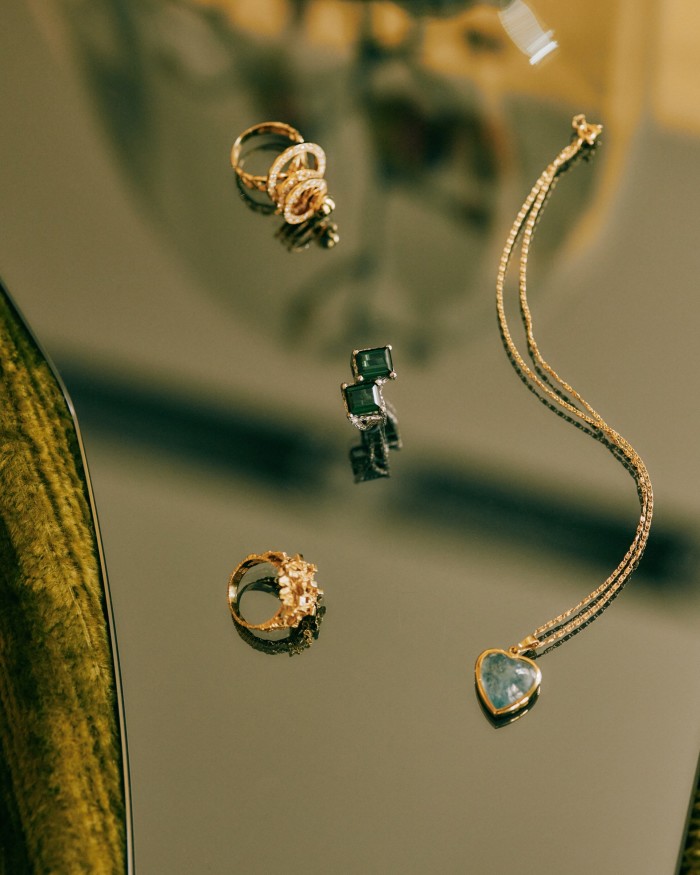 Clockwise from top left: a gold and diamond ring with spinning parts that belonged to Hirsh’s mother-in-law, an aquamarine pendant from her father, her grandmother’s gold nugget ring and the double tourmaline ring
