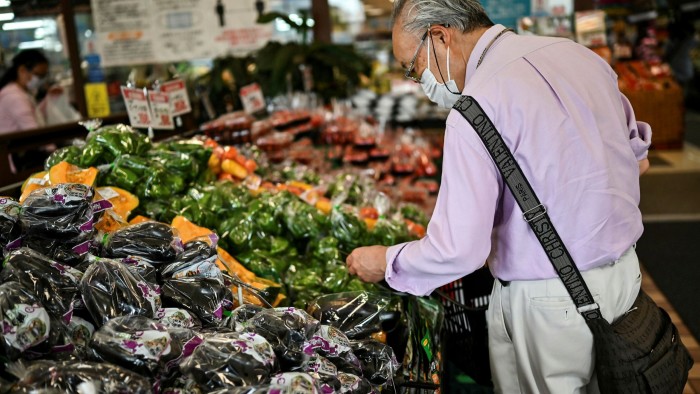 A man shops for food at a supermarket in Tokyo