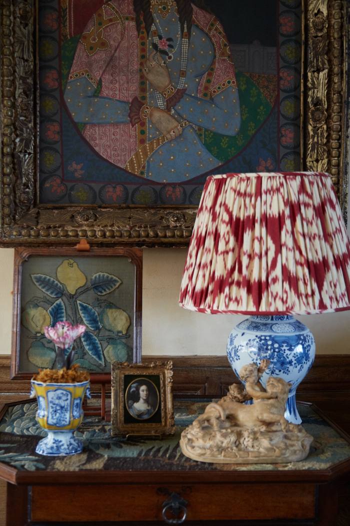 A Delft lamp from Robert Kime, a 17th-century needlework panel of lemons bought at Bonhams, and a portrait miniature by Casper Netscher found at a Brussels antique fair