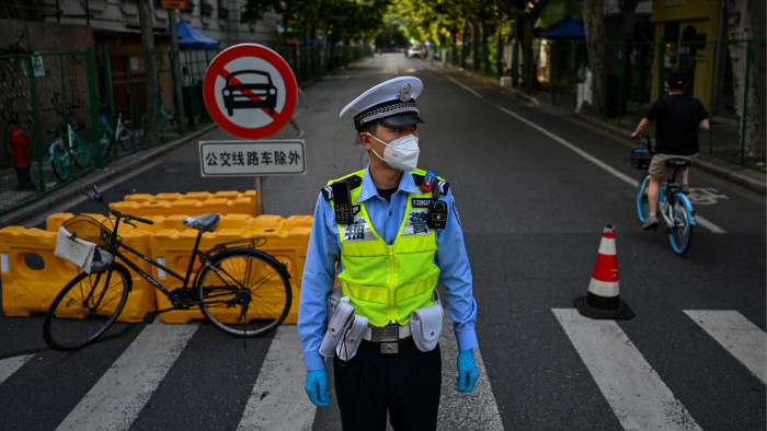 A police officer on an empty street in Shanghai during a Covid-19 lockdown in June 