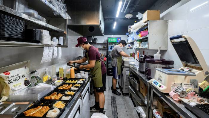 Fast food: a chef and co-worker prepare meals at a dark kitchen in Seoul