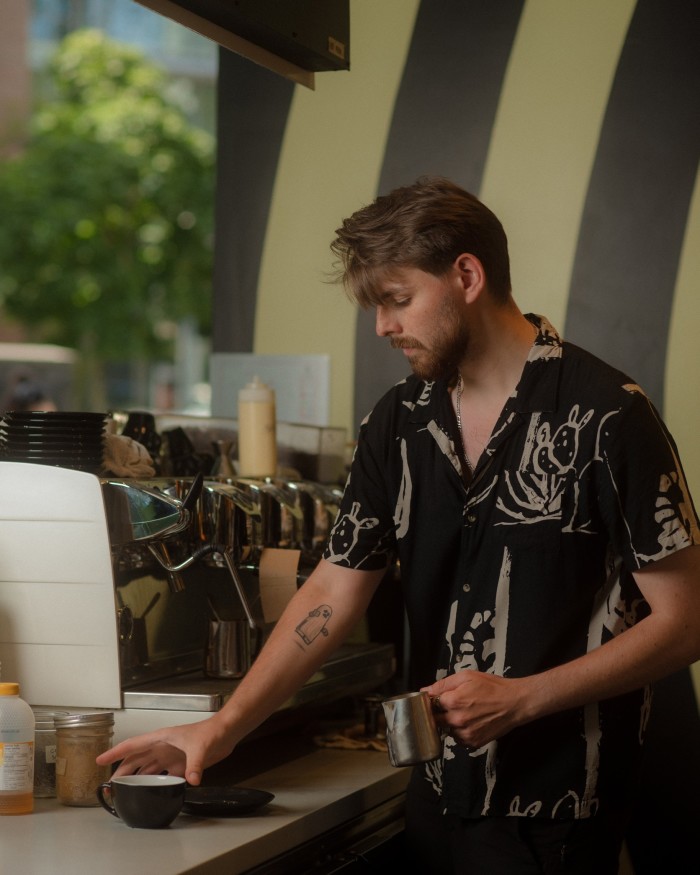 A male barista behind the counter at Kafka’s