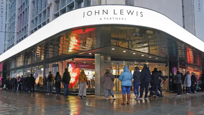 People queue outside John Lewis on Oxford Street in London