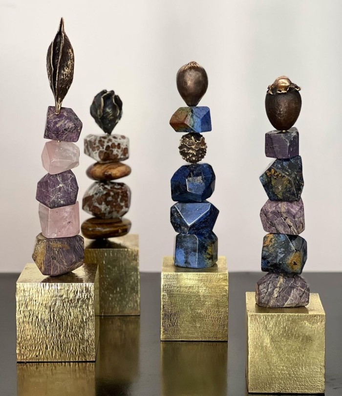 From left: pink lunar quartz and purpurite totem, petrified wood and garnet in limestone totem, dumortierite totem and sodalite and purpurite totem by Sarah Heinamann 