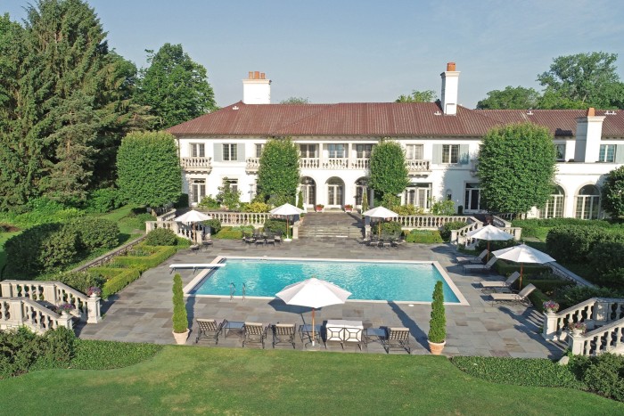 An estate with a swimming pool and expansive lawns