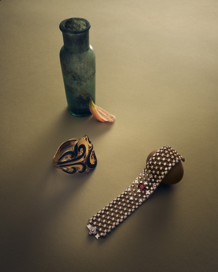 From left: Chopard rose-gold, spessartite-garnet and wood cuff. Louis Vuitton HIGH JEWELLERY gold, diamond and ruby Destiny bracelet