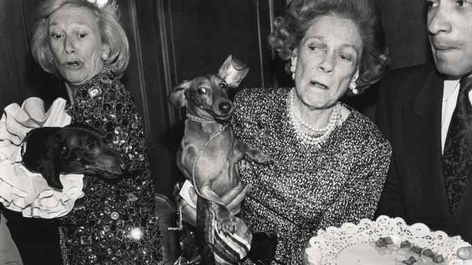 Iris Love and Brooke Astor with their dogs, Just Desserts and Dolly Astor, at a party hosted by Barbetta, Manhattan, February 1990