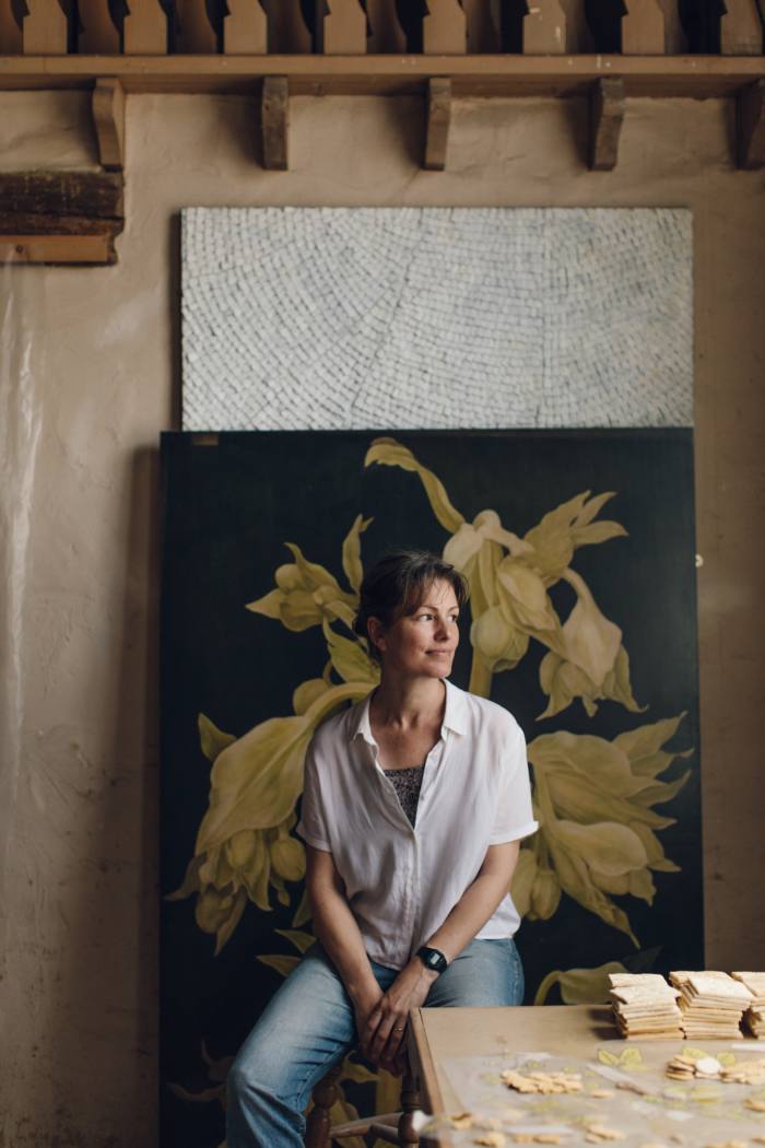 Sophie Coryndon in front of Green Hellebore, a work from her large-scale botanical series