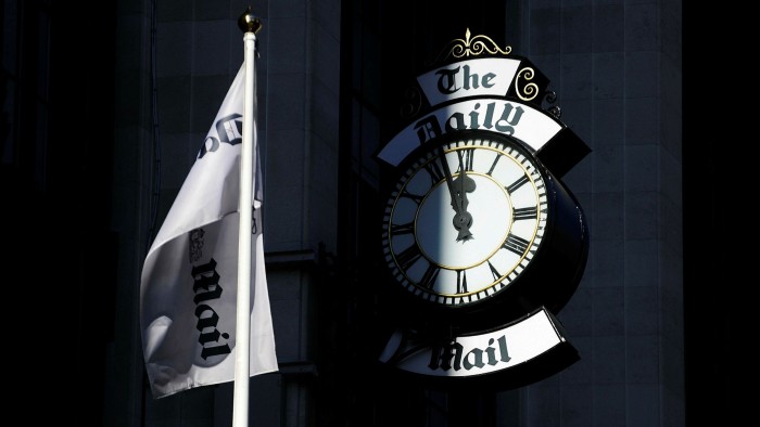 A clock on the side of the offices of the Daily Mail and in London