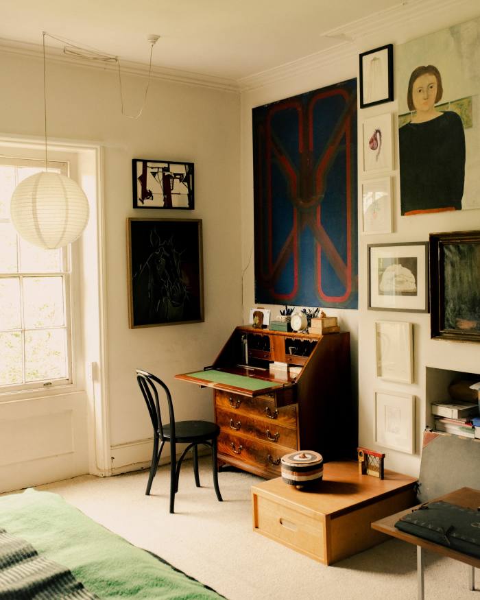 Adrian’s bedroom with a large abstract by Robyn Denny (above the desk), a watercolour by Suzanne Treister (in black frame at top, on right of Denny abstract), Flower of the Future by Joanna Kirk (second from top, on right of Denny abstract) and a self-portrait by Liza Fior when she was 18 (top right). A ceramic bowl by Sarah Staton and a metal sculpture by Telfer Stokes sit on a wooden storage box designed by Trevor Dannatt 