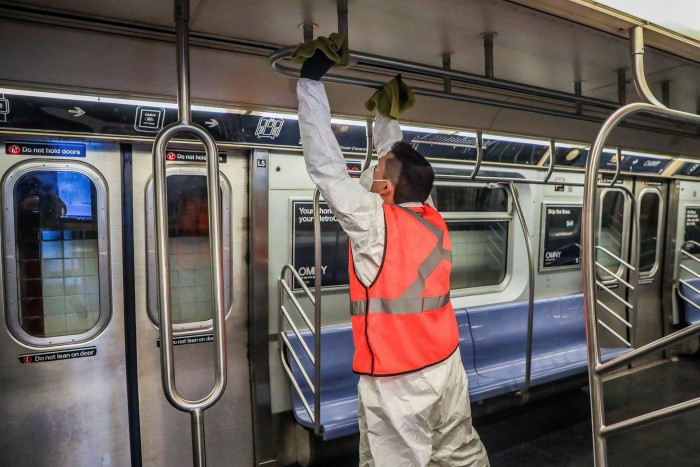 An employee cleans a subway car as part of decontamination efforts on May 17