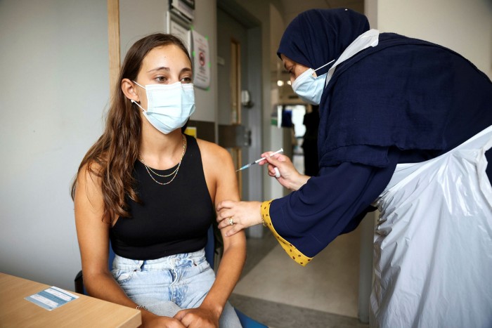 A Londoner receiving a Covid vaccine in August