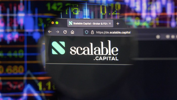 Scalable Capital company logo on a website with blurry stock market developments in the background, seen on a computer screen