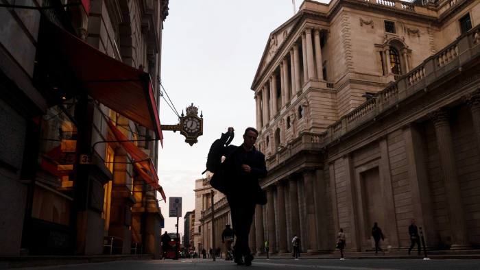 A commuter passes the Bank of England