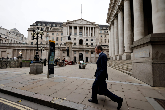 A pedestrian walks past the Bank of England in London