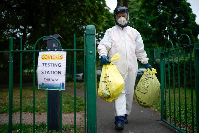 A Leicester city council employee at a testing centre. The UK initially abandoned mass testing in March as it lacked the capacity for a test-and-trace policy