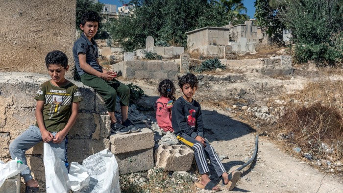 Vulnerable: Syrian refugee siblings outside their home in Amman, Jordan