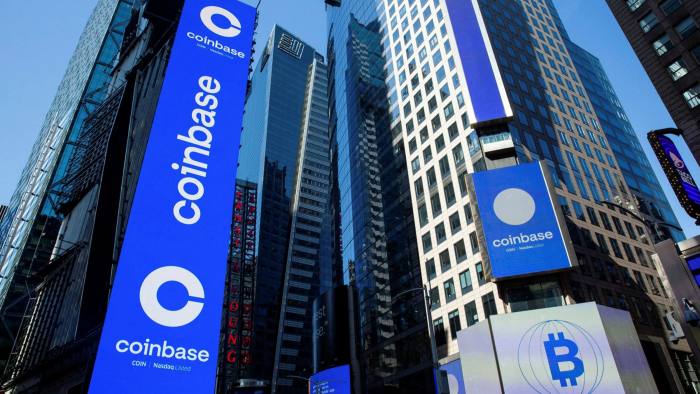 Monitors display Coinbase signage at the company’s IPO at the Nasdaq MarketSite