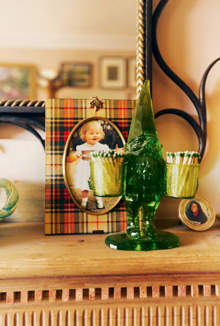 A green resin gnome and a photograph of Margot