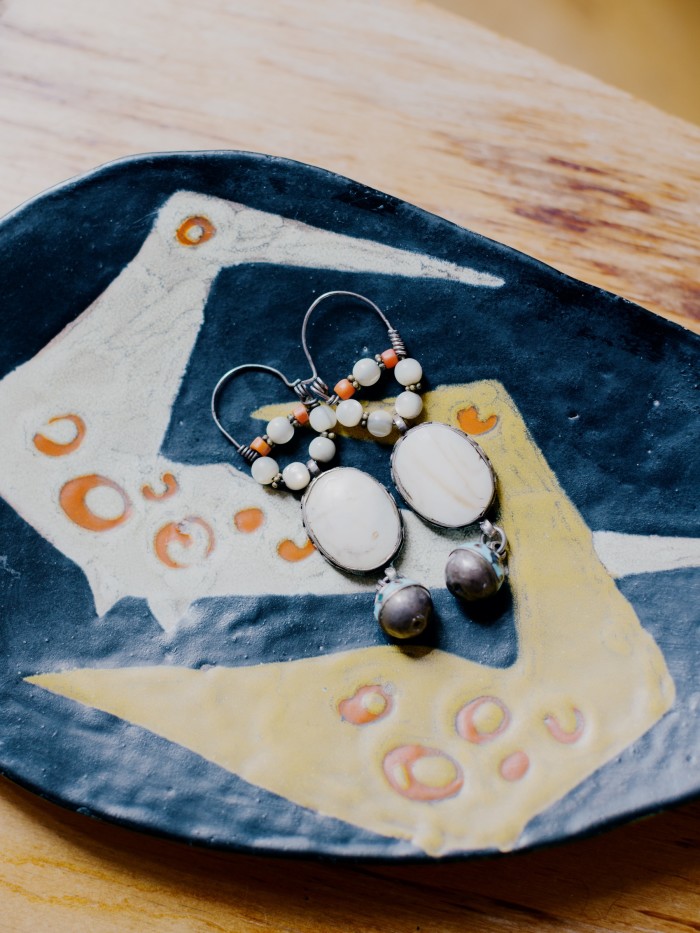 These earrings from Uzbekistan are his favourite gift; the ceramic plate is by Lívia Gorka