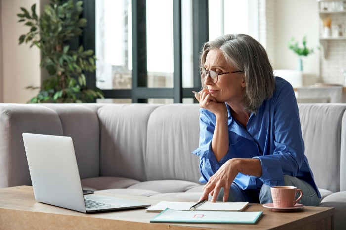 Senior mature older woman watching business training, online webinar on laptop