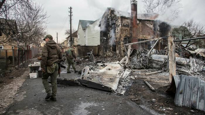 Ukrainian forces inspect a downed aircraft in Kyiv