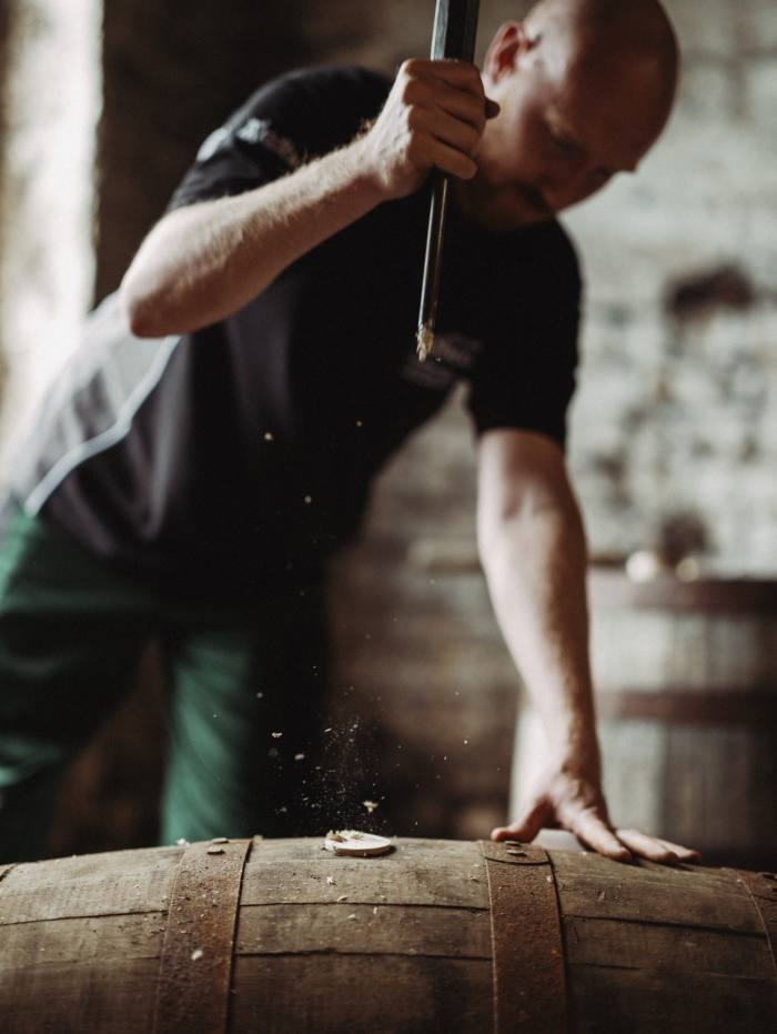 Hammering the bung into a cask