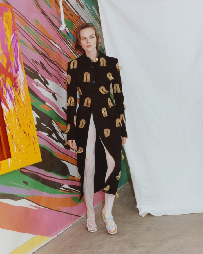 Proenza Schouler wool embellished coat, £7,721. Tiffany & Co gold and jade Elsa Peretti Bean necklace, £22,711. Tights and vintage shoes, handpainted by John Hurley. Artworks: Meta Paintings 09, 2022, and (behind) Mesh Installation, 2022, both by Márton Nemes