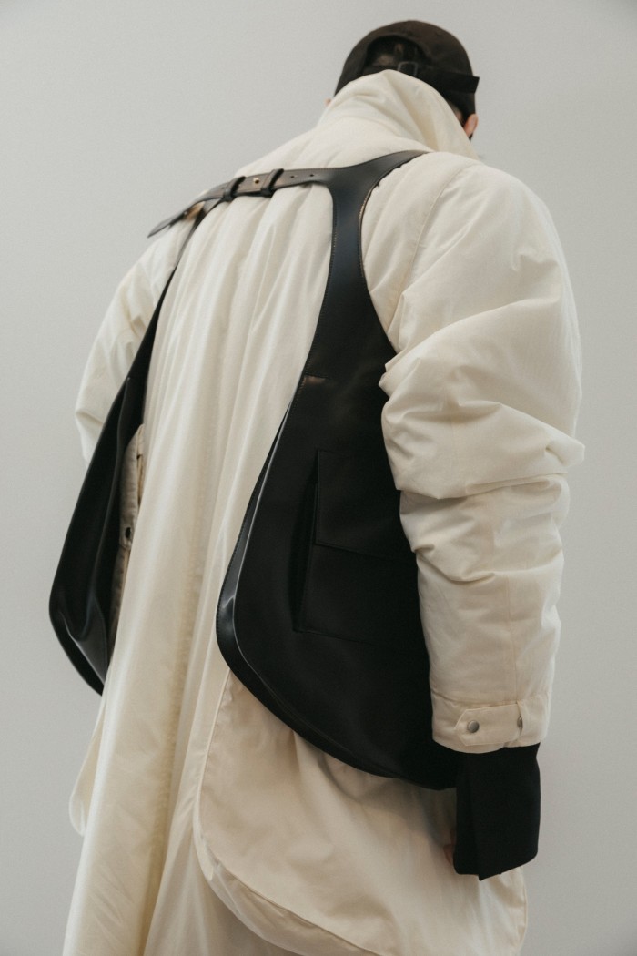 Cotton padded coat, $1,950, and leather Harness bag, $3,300