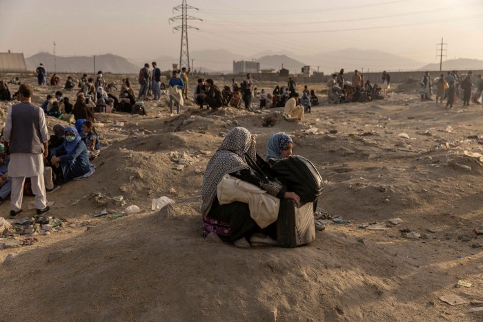 People hoping to flee the country gather outside Kabul airport, August 23
