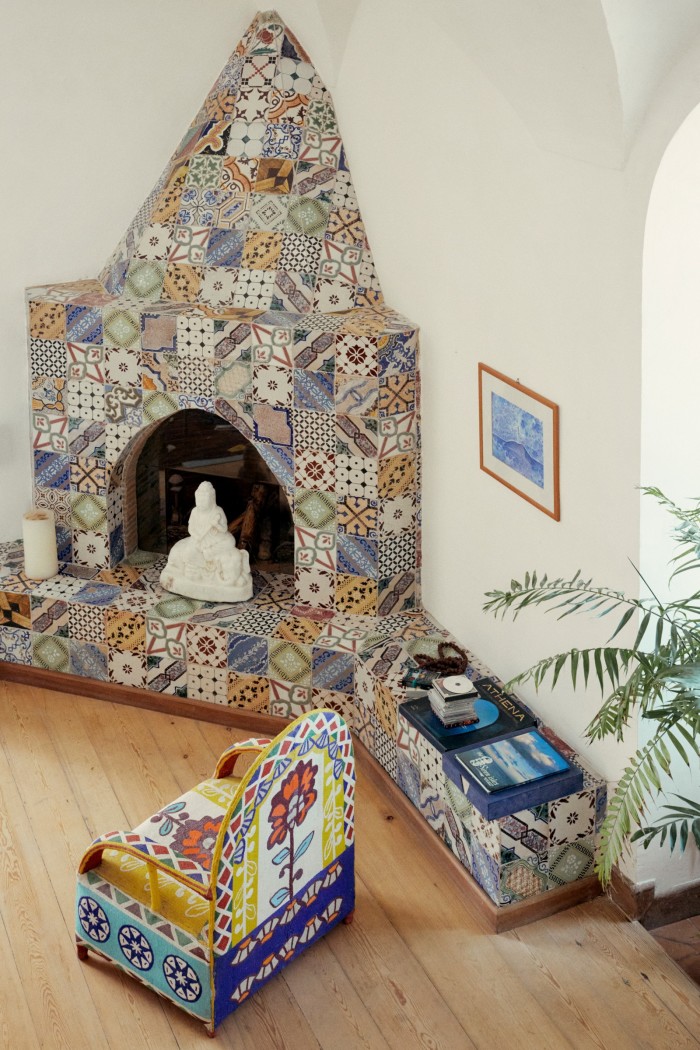 Reclaimed tiles decorate a fireplace in the tower