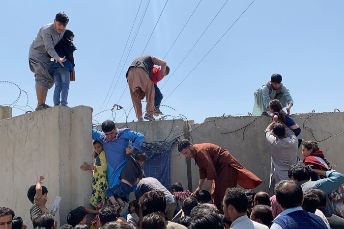 Afghans trying to scale the boundary at Kabul airport,  August 16