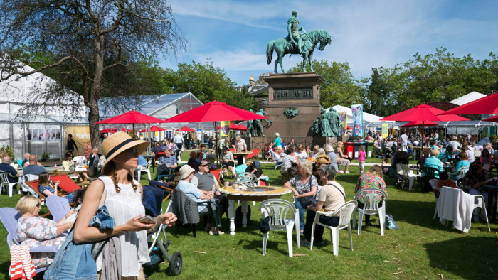 Visitors to the annual Edinburgh Book Festival enjoying the sunshine in Charlotte Square