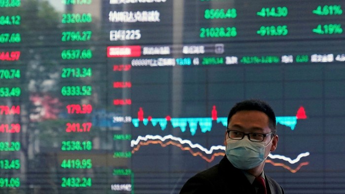 A man wearing a protective mask inside the Shanghai Stock Exchange