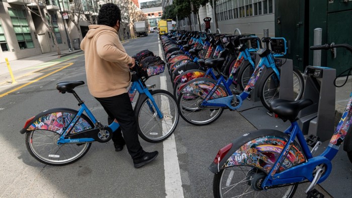 A person prepares to ride a Lyft bike in San Francisco 