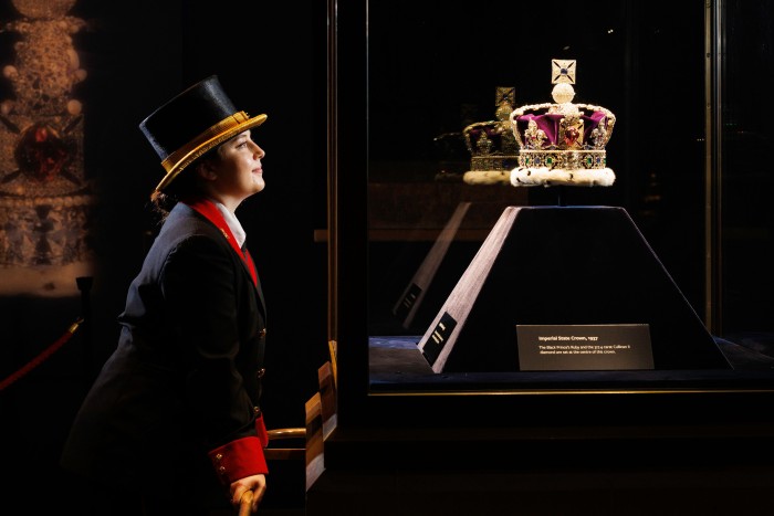 The Jewel House Treasury, showing Hazel Dincer (Jewel House Warder) looking at the Imperial State Crown. 