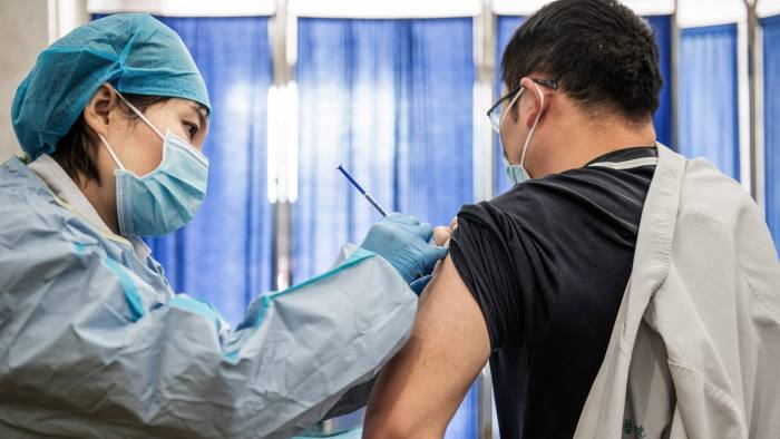 A medical staff member receives a booster shot of the Sinopharm Covid-19 coronavirus vaccine at a hospital in Wuhan, China
